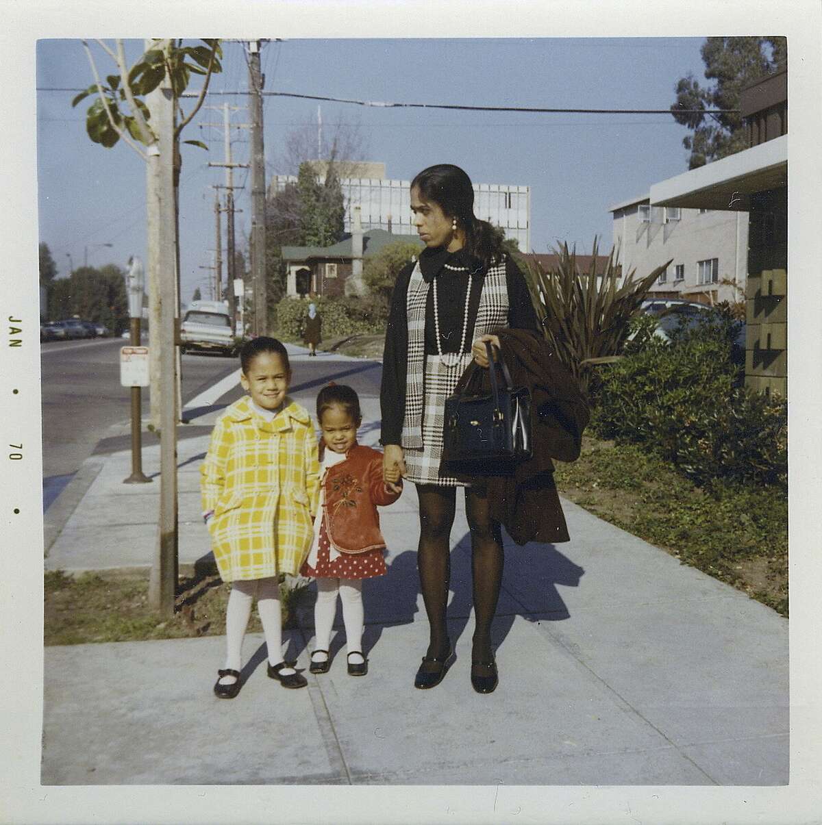 FILE - This January 1970 photo provided by the Kamala Harris campaign shows her, left, with her sister, Maya, and mother, Shyamala, outside their apartment in Berkeley, Calif. On Friday, June 28, 2019, The Associated Press reported on stories circulating online incorrectly asserting that Harris lied during the Thursday, June 27, 2019 Democratic debate when she said she was part of �the second class to integrate� Berkeley Public Schools, with users sharing Berkeley High School yearbook photos showing black and white students attending the school in the 1960s. Harris, however, wasn�t talking about Berkeley High School. She didn�t enter the school system until 1969, at age five. The school didn�t agree to desegregate all 14 elementary schools until the beginning of the 1968 school year. (Kamala Harris campaign via AP)