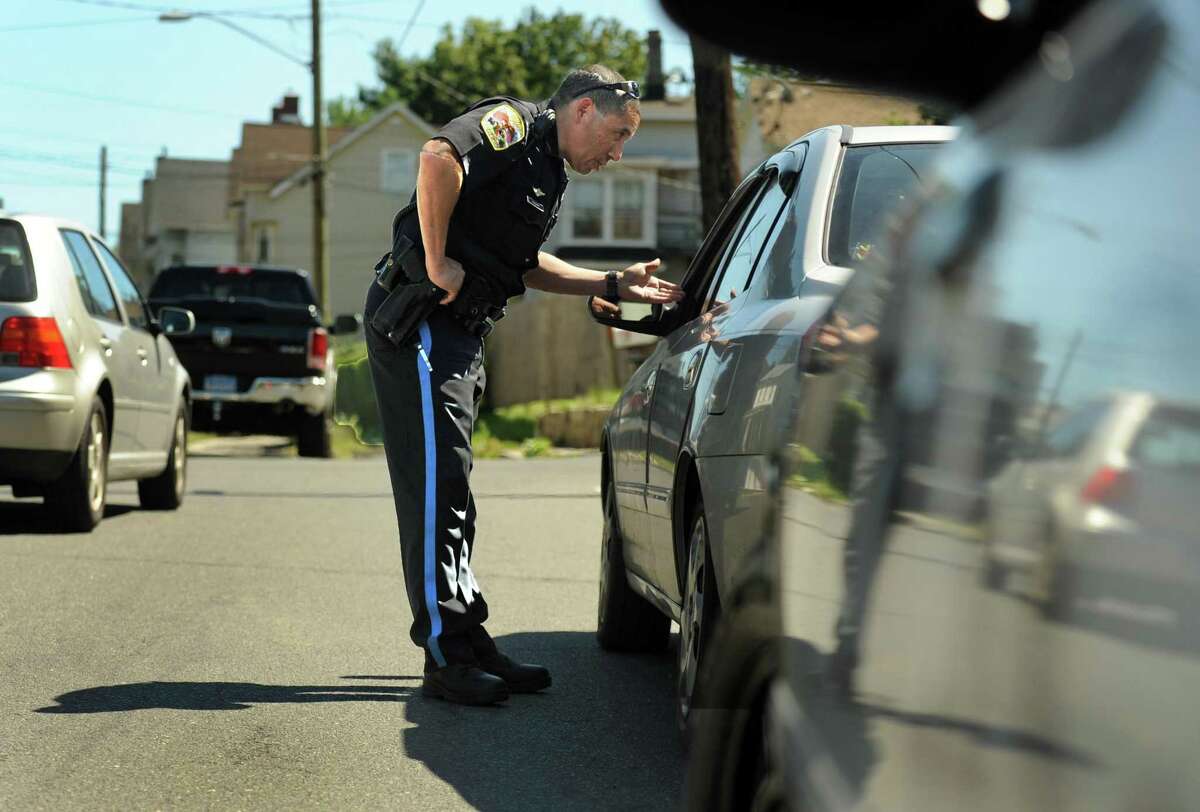 Danbury Police Officer Ricard DeJesus stops a car on West Street on Friday, Sept. 12, 2014, after observing the driver using a mobile device.