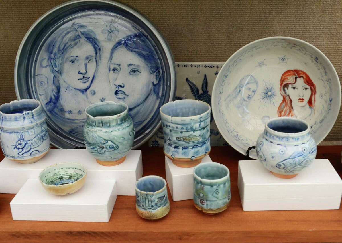 Visitors to Mathews Park peruse the art including ceramics by Janis Cutler Gear during the Norwalk Arts Festival Saturday, June 29, 2019, in Norwalk, Conn.The Norwalk Art Festival features the works of 125 juried artists from local to national talent. They will exhibit a wide variety of media including, photography, drawing, ceramics, jewelry, painting, mixed media, printmaking, fiber, metal sculpture and glass. The festival continues Sunday from 12- 5pm