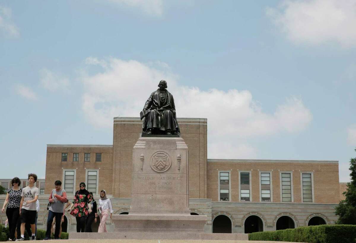 A tour moves past the statue of Rice University founder William Marsh Rice, who chartered the school with a hefty endowment for “the white inhabitants” of Texas.