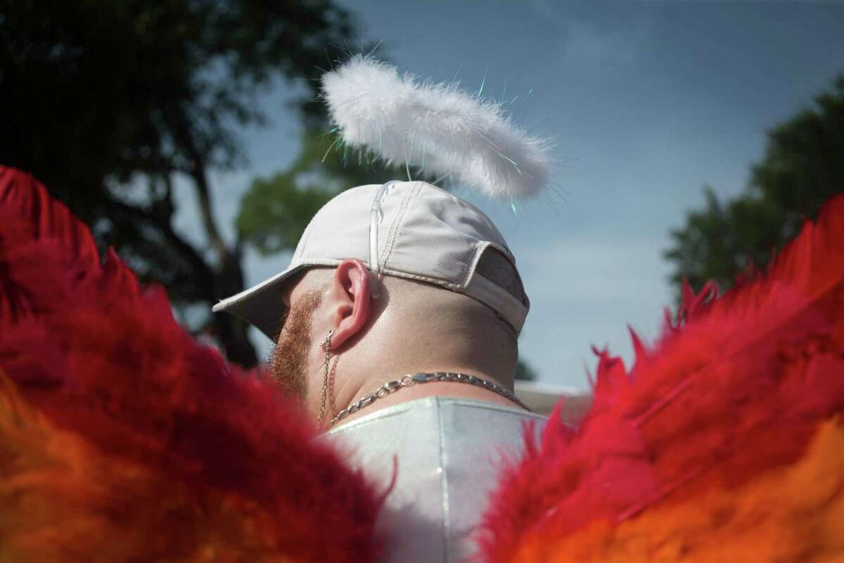 Kevin Perkins, 24, wears rainbow angel rings and a halo at 2019 Pride "Bigger Than" Texas Saturday, June 29, 2019 at Crockett Park in San Antonio. "It [the festival] is so raw and natural. There's a community as soon as you get your wristband" shared Perkins. The celebration included Pride Championship Wrestling, "We All Love the Same" mass wedding, and performers. Rebecca Slezak/Staff photographer