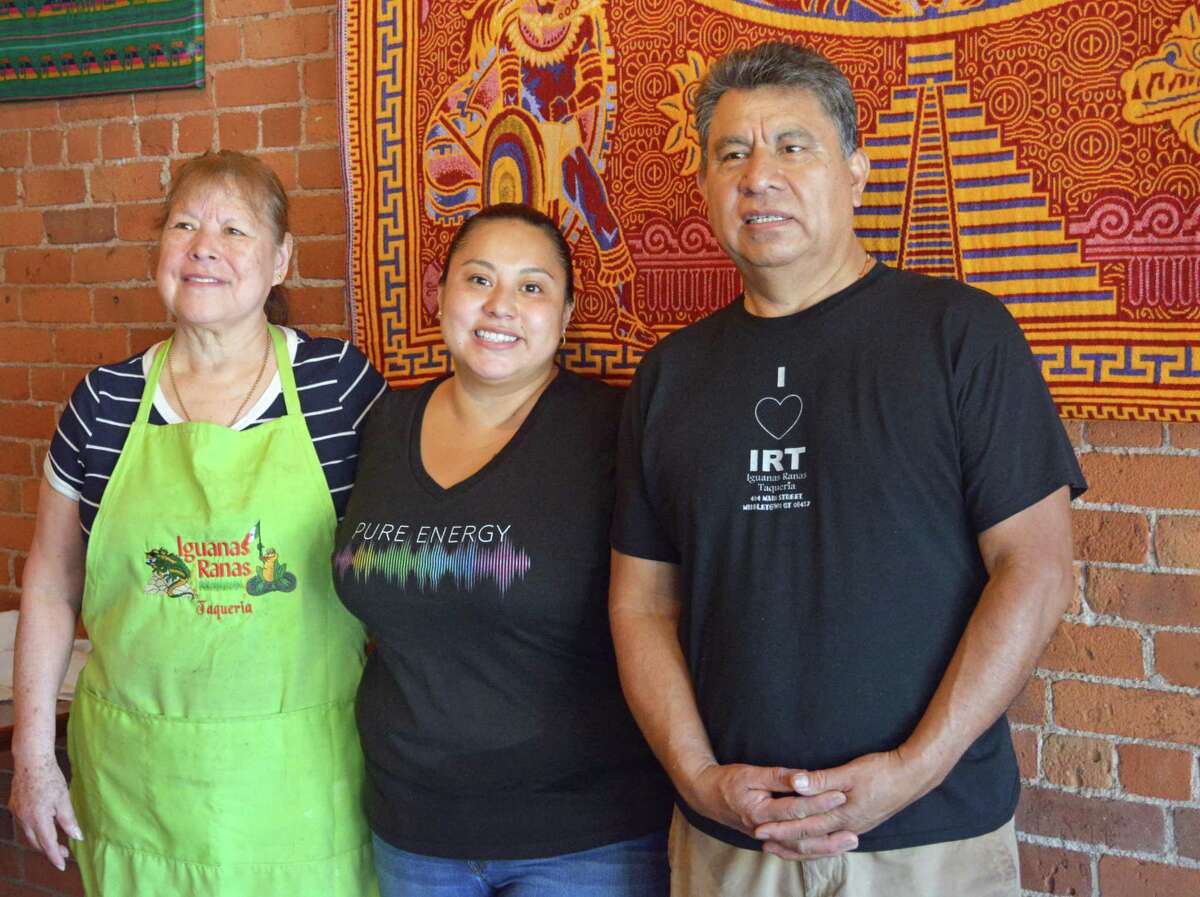 Iguanas Ranas Taqueria owners Angela Martinez, left, and Hipolito Martinez, right, stand with daughter Martha Martinez Thursday morning at the 484 Main St., Middletown, restaurant. The family opened the eatery in 2008 and made the difficult decision recently to close July 3.