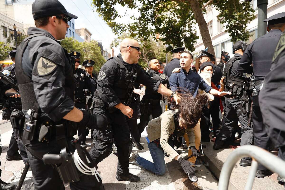 Police move in to break up a group of protesters that blocked Market Street at the Gay Pride Parade. The group brought the parade to a standstill at mid-day Sunday, June 30, 2019.