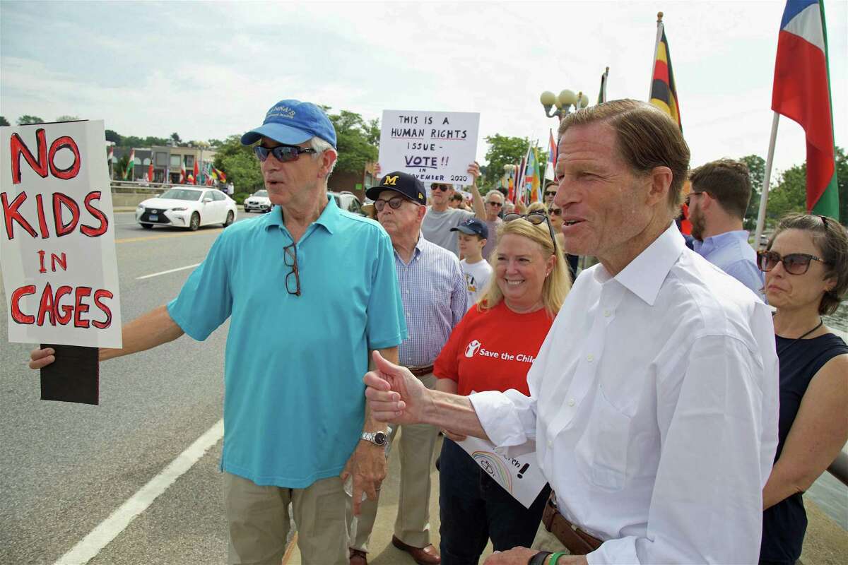 Performer and Weston resident James Naughon, left, and U.S. Sen. Richard Blumenthal, at the protest against U.S. detention centers on the Ruth Steinkraus Cohen Bridge Saturday, June 29, 2019, in Westport, Conn.