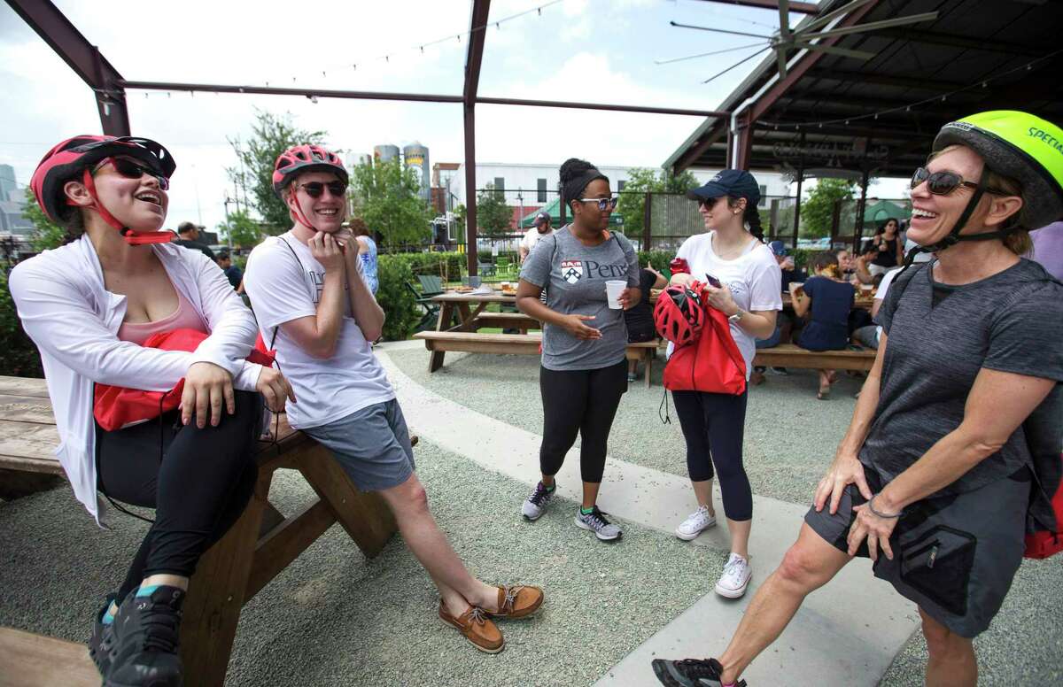 After drinking some beer and hanging out for a little, co-workers Claudia Gamica, from left, Paul Kieffer, Alexis Désiré, Kaitlin Prior and Marlene Barnett small chat before taking on the Tour de Brewery's Downtown and Eado Tour from Saint Arnold Brewing Company on Saturday, June 22, 2019, in Houston. The four-hour bicycle tour started from Saint Arnold Brewing Company, to Sigma Brewing Company and 8th Wonder Brewery, then go back to Sant Arnold Brewing Company.