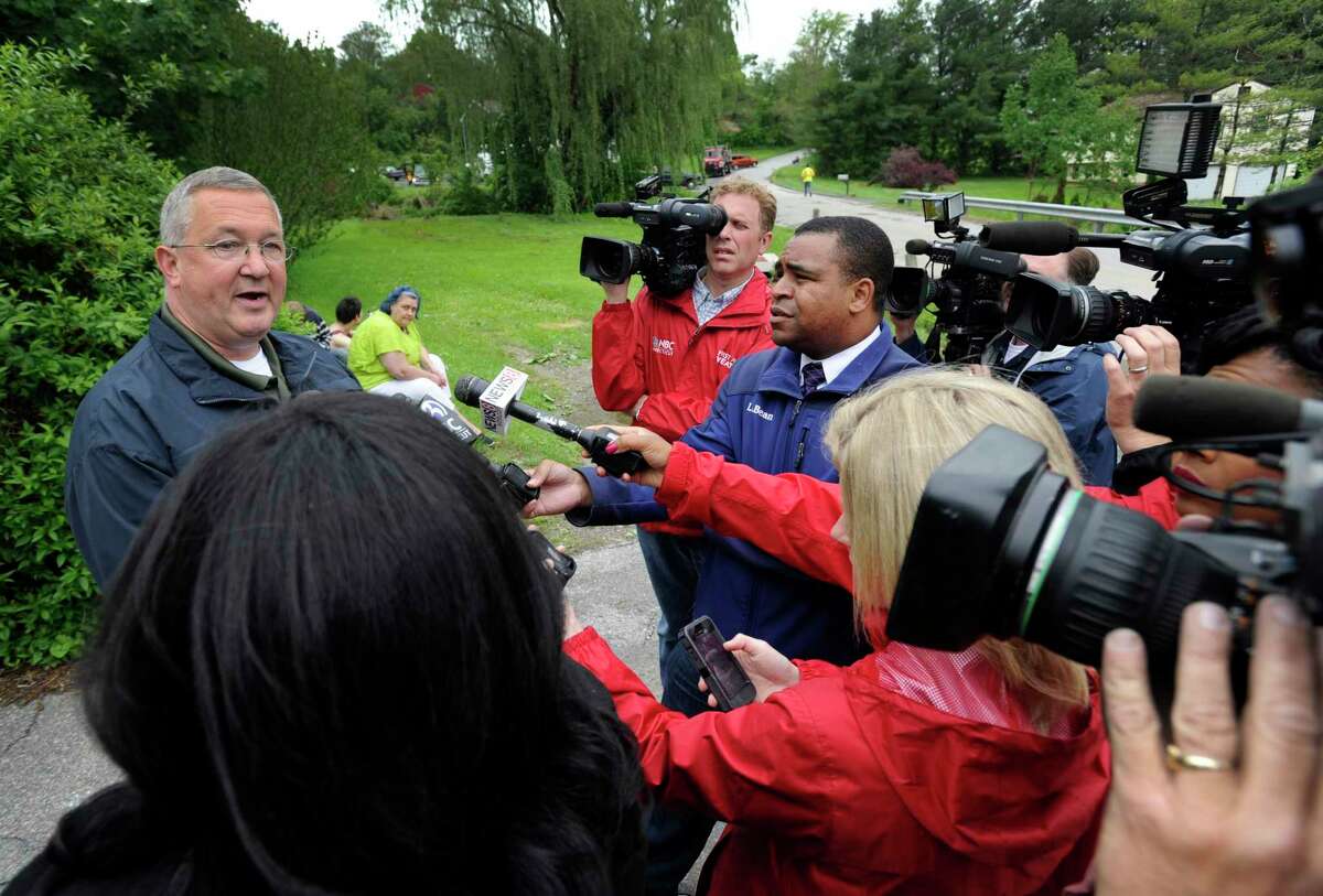 Lt. Lawrence Ash meets with the media on Van Car Road in New Milford, Conn., on Wednesday, May 28, 2014, to discuss a storm related fatality on the road the evening before.