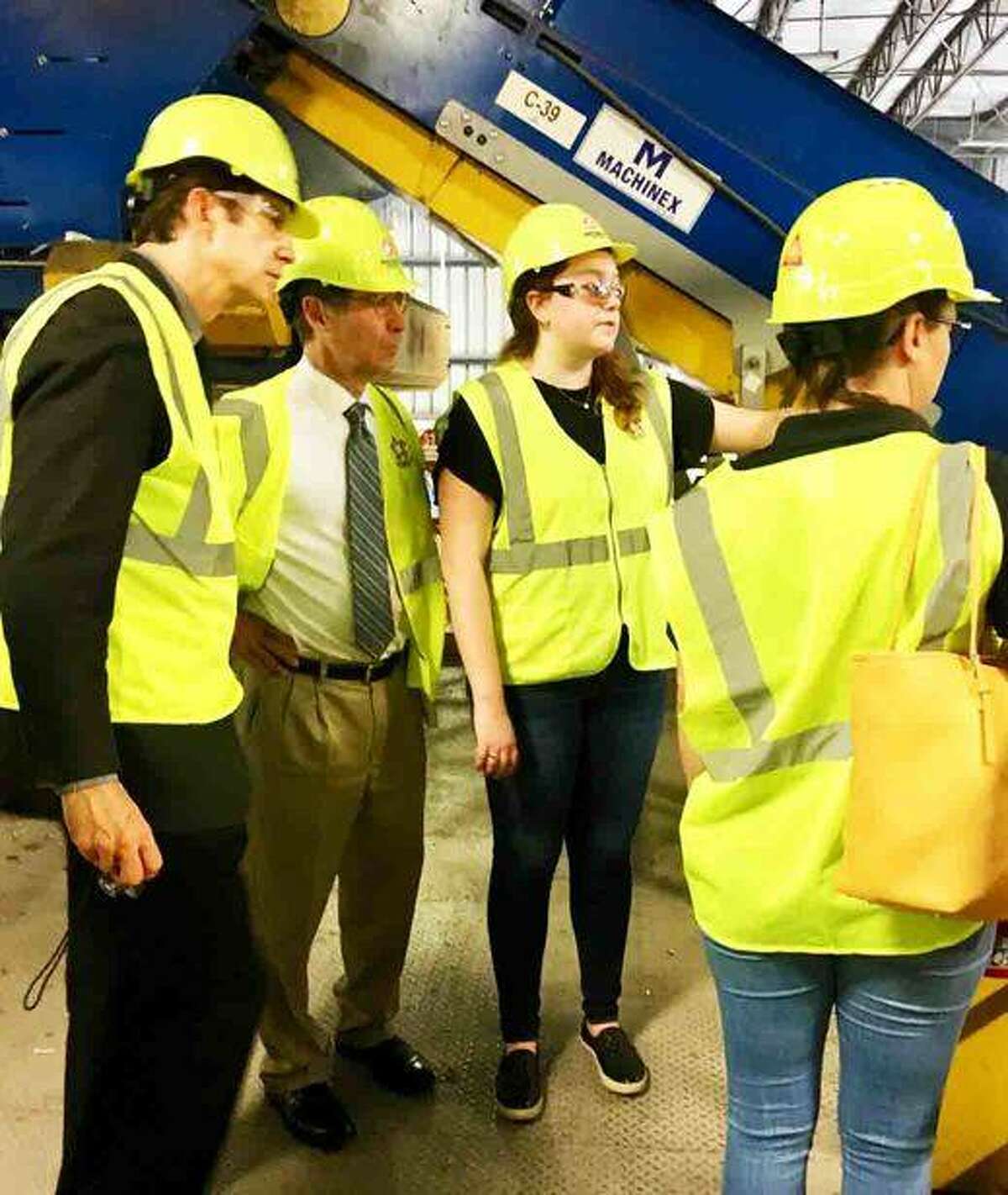 (L-R) Republic Services Leadership Trainee Megan Sexton (center) gives Madison County Chairman Kurt Prenzler a tour of Republic’s Material Recovery Facility in Hazelwood, Mo. on Friday with Planning and Development Deputy Administrator Chris Doucleff and Sustainability Coordinator Andrea Campbell Yancey. Madison County and City of Collinsville officials took the tour of the facility that recycles 300 tons of material daily
