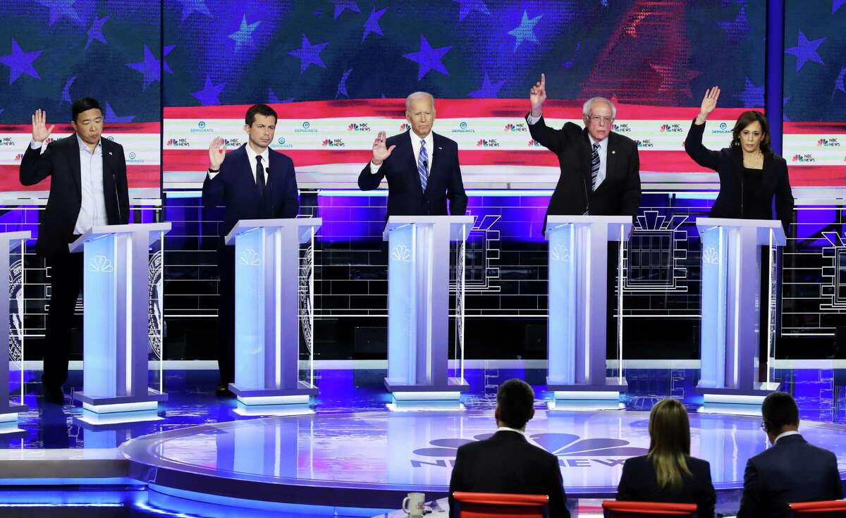 *** BESTPIX *** MIAMI, FLORIDA - JUNE 27: Democratic presidential candidates (L-R) former tech executive Andrew Yang, South Bend, Indiana Mayor Pete Buttigieg, former Vice President Joe Biden, Sen. Bernie Sanders (I-VT) and Sen. Kamala Harris (D-CA) raise their hands during the second night of the first Democratic presidential debate on June 27, 2019 in Miami, Florida. A field of 20 Democratic presidential candidates was split into two groups of 10 for the first debate of the 2020 election, taking place over two nights at Knight Concert Hall of the Adrienne Arsht Center for the Performing Arts of Miami-Dade County, hosted by NBC News, MSNBC, and Telemundo. (Photo by Drew Angerer/Getty Images)