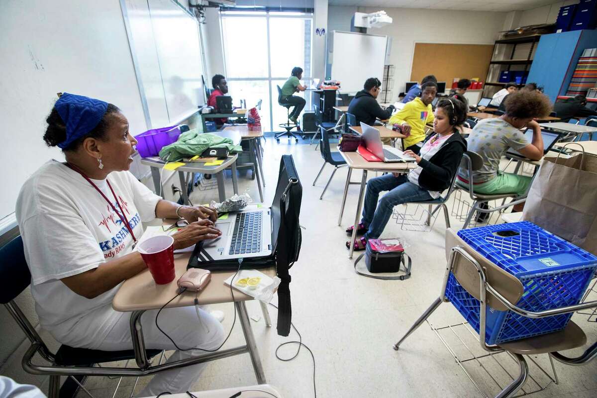 English teacher Trae Muhammad works with her students as they work on their assignments during a summer school class at Kashmere High School on Thursday, June 27, 2019, in Houston.