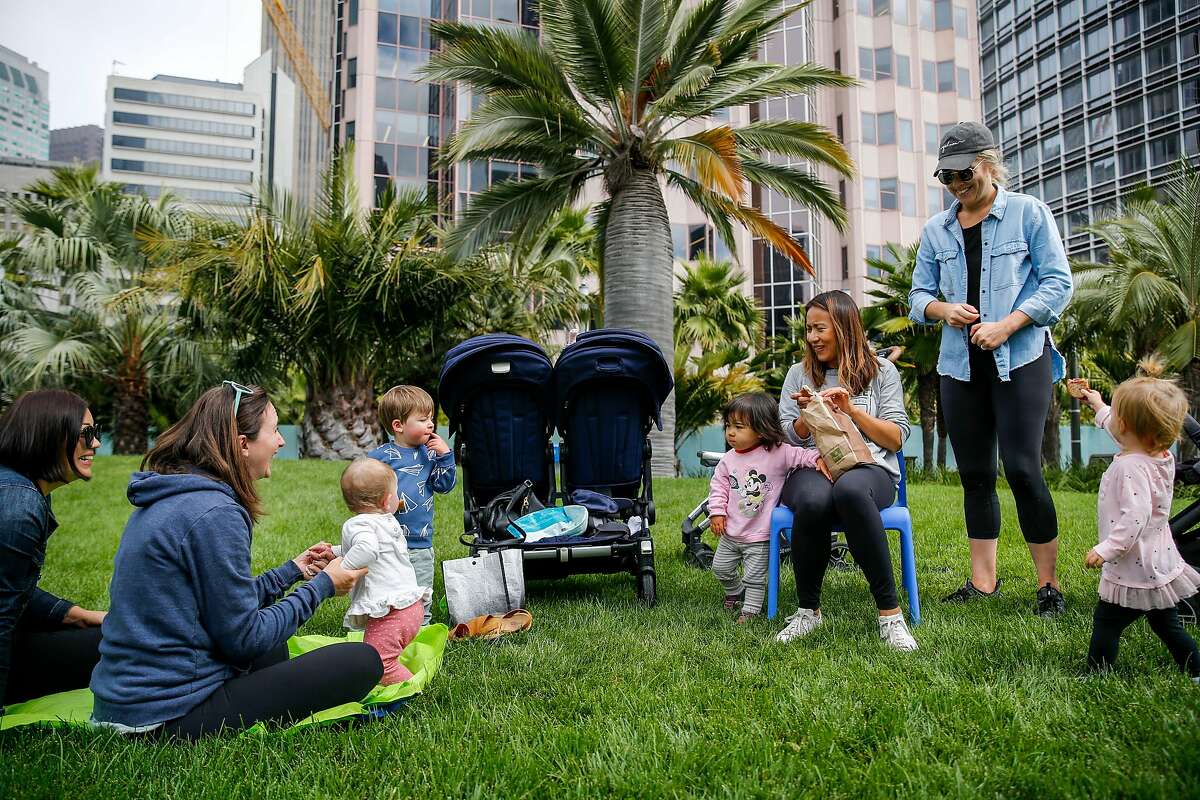From left, Stephanie Hudson, Hellen Sparrow and children Jaimie Sparrow, 9 months, Joshua Sparrow, 2; laugh with Jaz Aiwazian, 1, and her mother Yili Aiwazian and McKenzie Armstrong and her daughter Amelia Armstrong, 1, as they meet for a playdate at the reopened Salesforce Park Monday, July 1, 2019, in San Francisco, Calif. The Salesforce Transit Center was initially opened in August 2018 but closed a month later after a cracked beam supporting the rooftop was discovered. After a nine month construction period to fix the issue the rooftop park has now reopened.