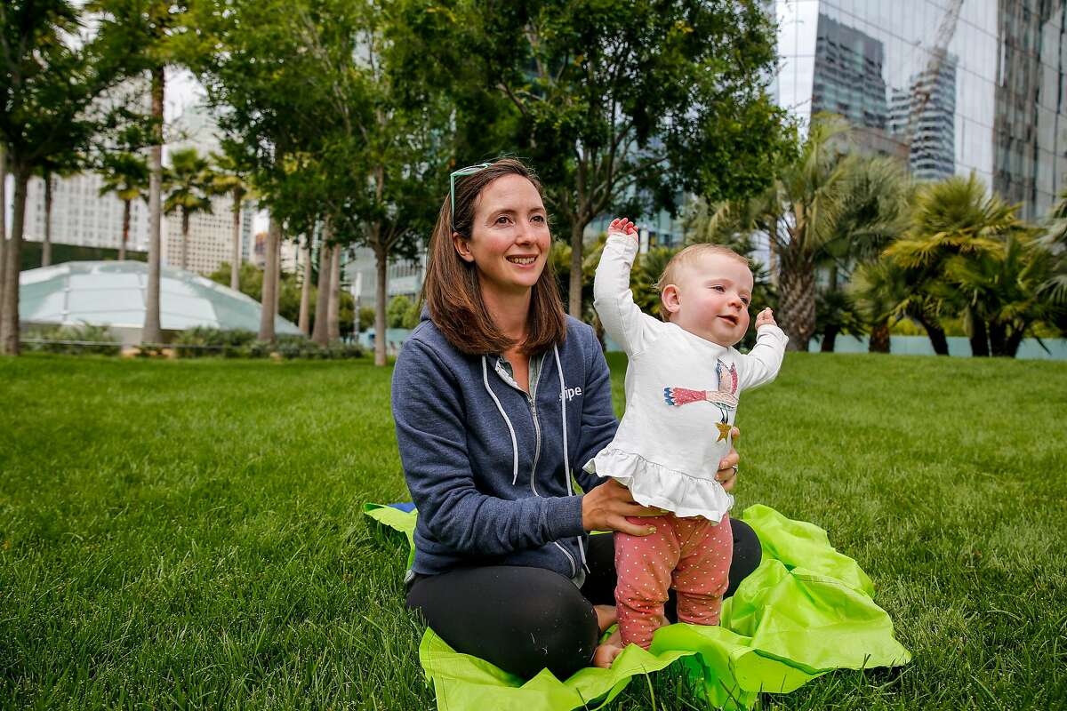 Helen Sparrow holds her daughter Jamie Sparrow, 9 months, as they have a playdate at the reopened Salesforce Park Monday, July 1, 2019, in San Francisco, Calif. The Salesforce Transit Center was initially opened in August 2018 but closed a month later after a cracked beam supporting the rooftop was discovered. After a nine month construction period to fix the issue the rooftop park has now reopened.