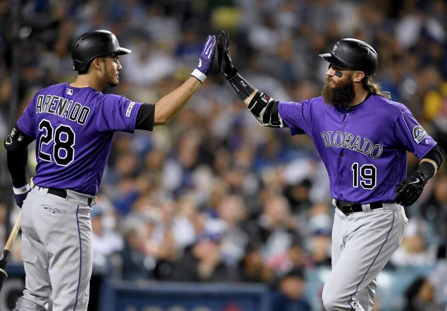 The jersey of Colorado Rockies third baseman Nolan Arenado hangs in his  locker as members of the media tour the new clubhouse in Coors Field as  workers prepare for the baseball team's