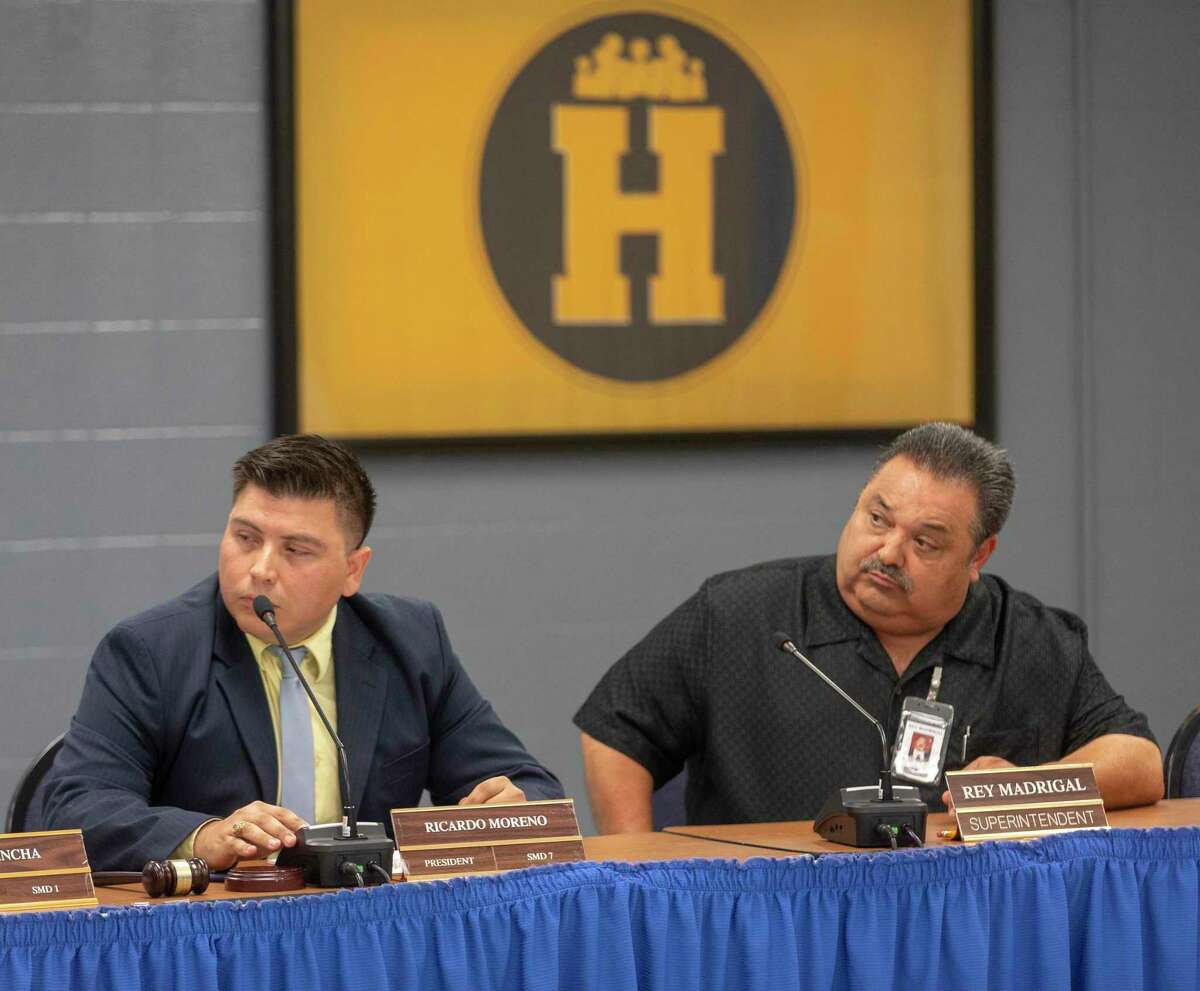 Harlandale ISD board president Ricardo Moreno, left, and superintendent Rey Madrigal listen Monday to another board member during a meeting to discuss the board’s response to a looming state takeover of the school district.