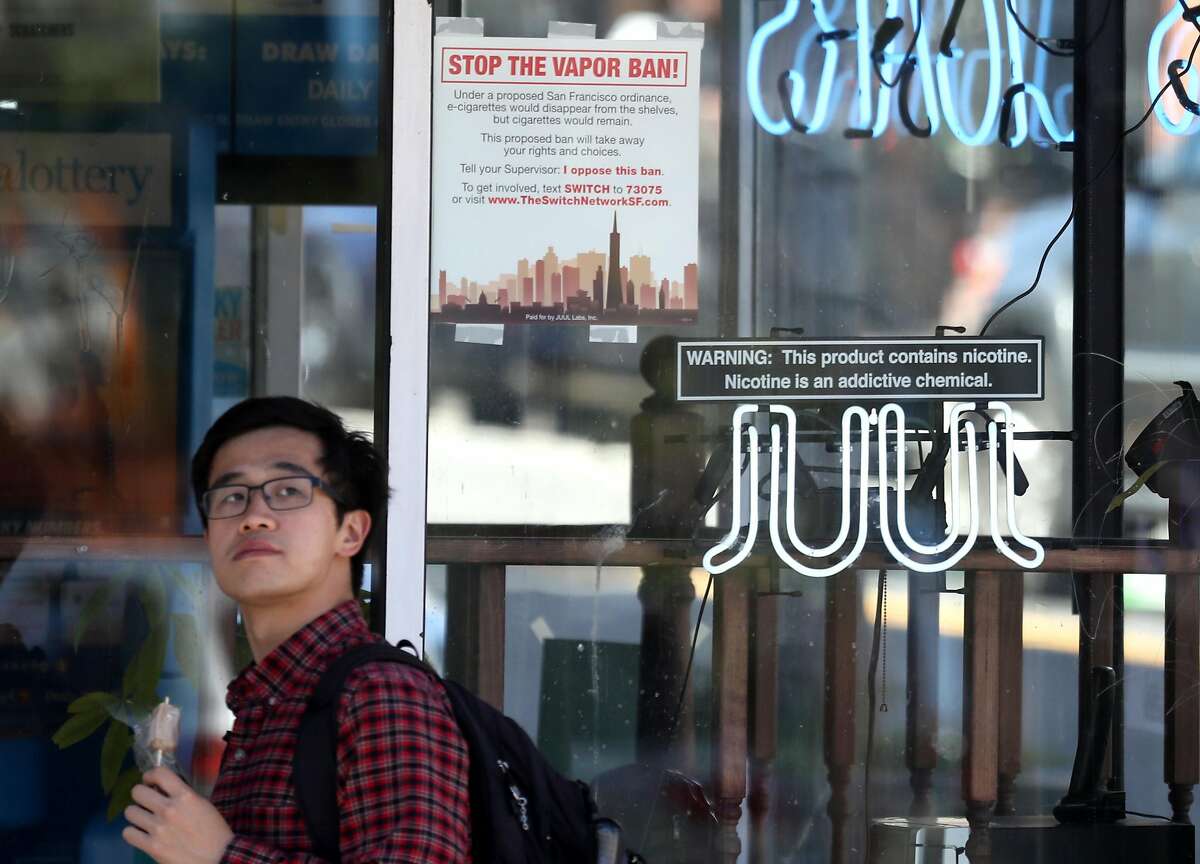 SAN FRANCISCO, CALIFORNIA - JUNE 25: A pedestrian walks by a neon sign advertising Juul e-cigarettes on June 25, 2019 in San Francisco, California. The San Francisco Board of Supervisors voted unanimously, 11-0, to be the first city in the United States to ban e-cigarettes, nicotine pods and devices that have not been approved by the Food and Drug Administration. (Photo by Justin Sullivan/Getty Images)