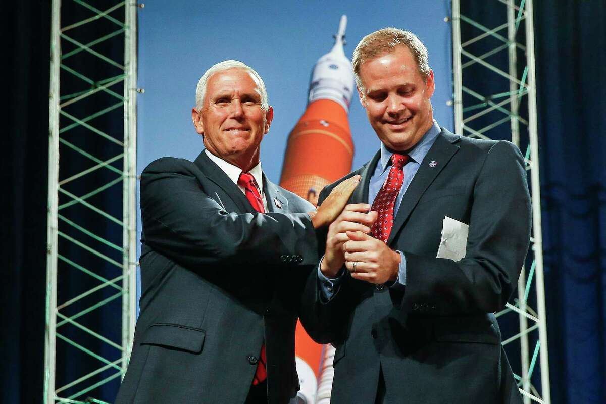 Vice President Mike Pence greets NASA Administrator Jim Bridenstine before speaking to NASA's Johnson Space Center employees about the future of human space exploration at Teague Auditorium Thursday Aug. 23, 2018 in Houston.