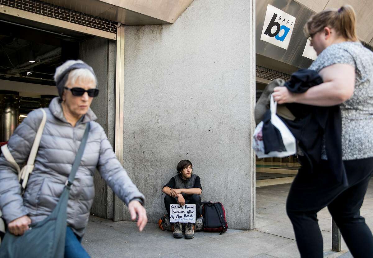 Jeffrey, who didn't provide his last name, panhandles while sitting outside of the Powell Street BART Station in San Francisco, Calif. Tuesday, July 2, 2019.