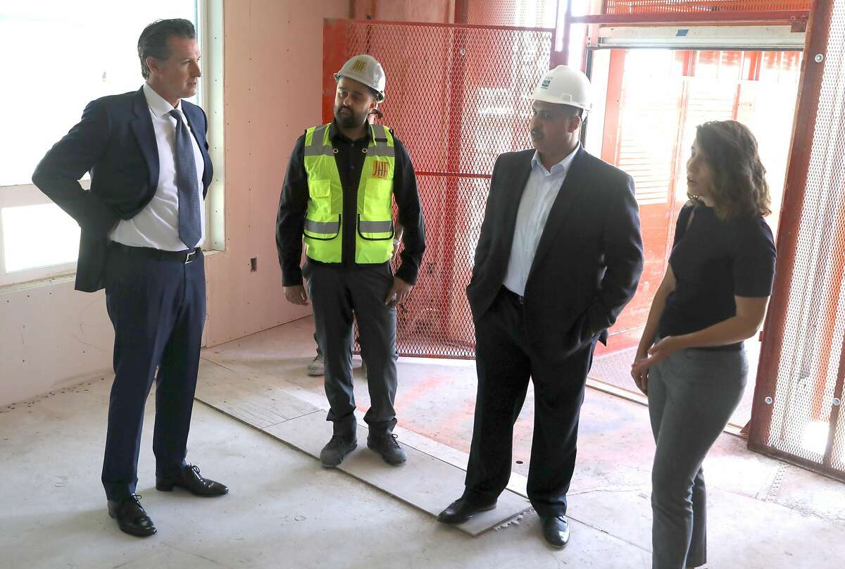 Left to right--Governor Gavin Newsom, JHF project manager Kyan Hakimi, VP of real estate development Welton Jordan of EAH housing, and Emeryville mayor Ally Medina take a look at Estrella Vista Apartments, a new affordable housing development under construction on Tuesday, July 2, 2019, in Emeryville, Calif.