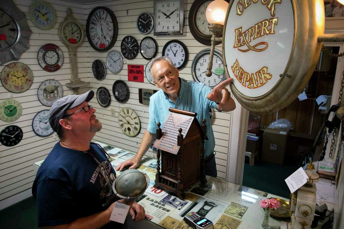 Owner Ralph Pokluda points out an antique cast iron sign in his clock store during a special tag sale for collectors at the Chappell Jordan Clock Gallery on Saturday, June 1, 2019, in Houston.