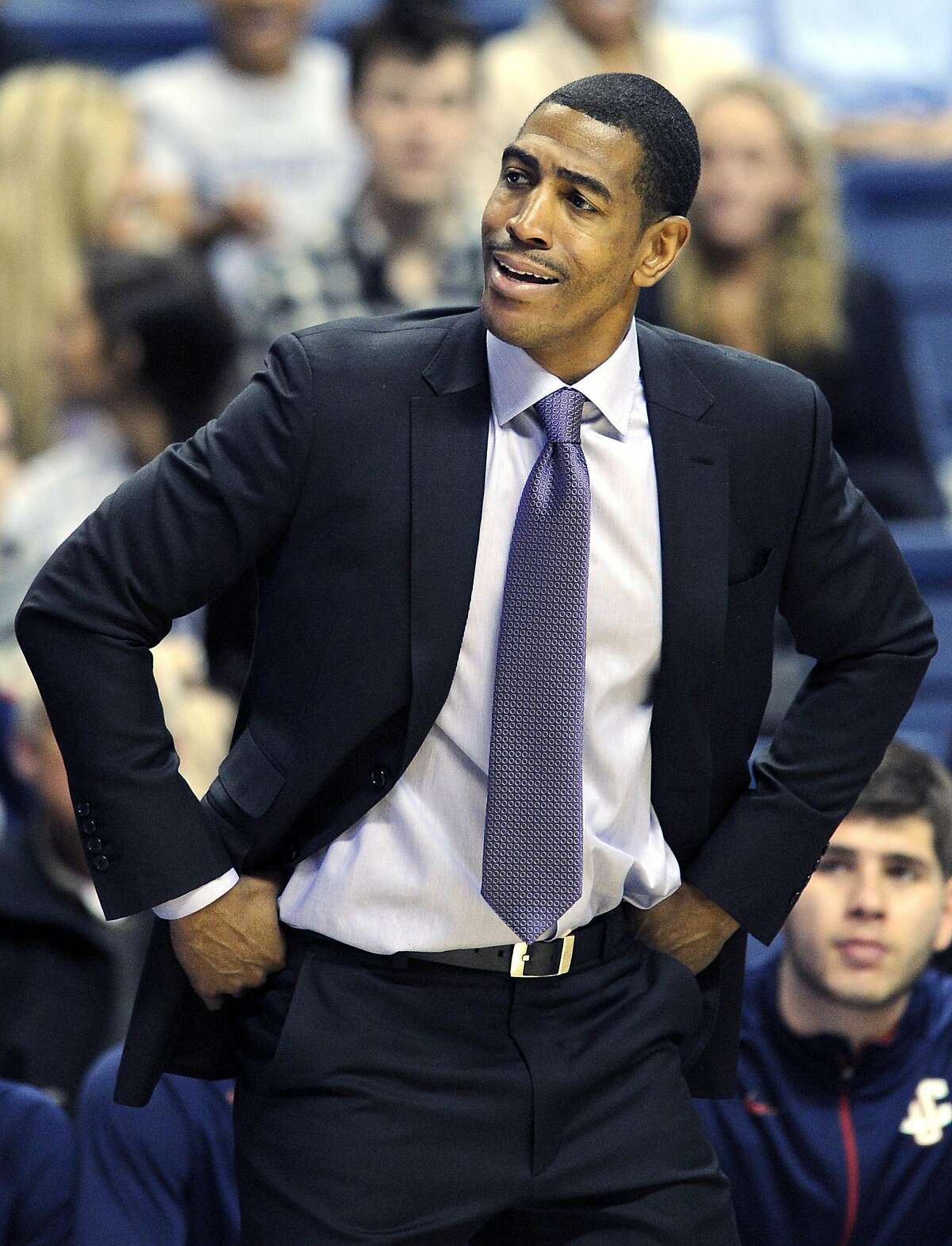 Connecticut coach Kevin Ollie reacts to a call during the second half of his team's 57-49 victory over Harvard in an NCAA college basketball game in Storrs, Conn., Friday, Dec. 7, 2012. (AP Photo/Fred Beckham)