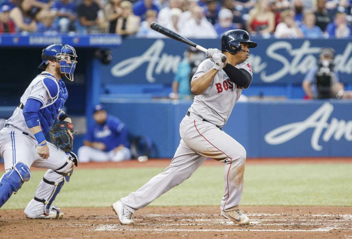 TORONTO, ONTARIO - JULY 2: Rafael Devers #11 of the Boston Red Sox hits a two RBI single against the Toronto Blue Jays in the third inning during a MLB game at the Rogers Centre on July 2, 2019 in Toronto, Canada. (Photo by Mark Blinch/Getty Images)