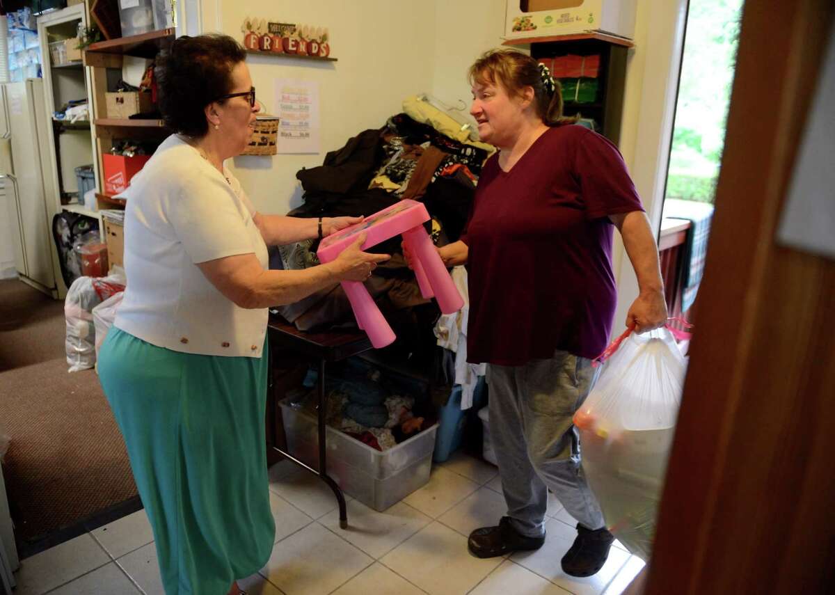 Theresa Viva, manager at A Second Chance Thrift Shop, left, accepts donations on Tuesday, July 2, 2019, in Colonie, N.Y. Viva donates all the proceeds from the shop to the American Italian Heritage Museum next door to preserve her past and help the community. (Catherine Rafferty/Times Union)