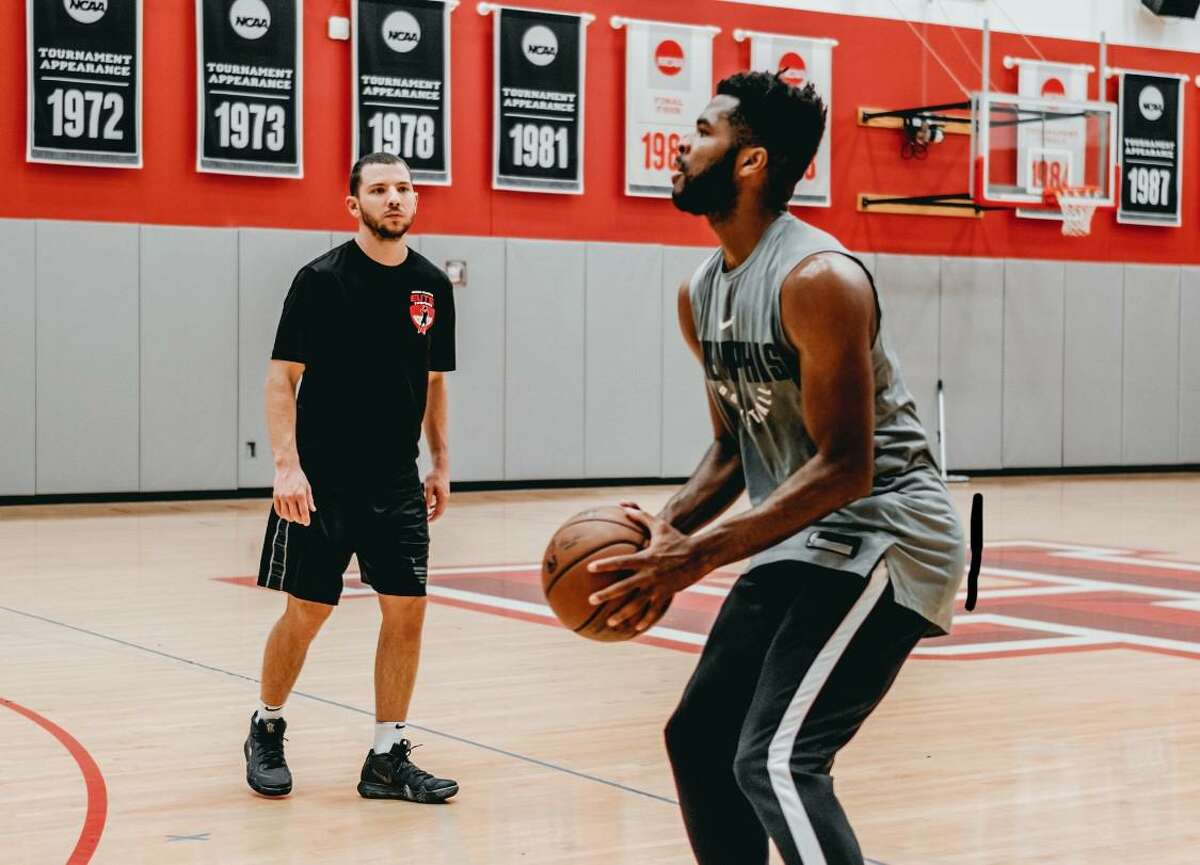 Trainer Aaron Miller, left, and NBA hooper Andrew Harrison work on shooting during a training session. Miller, a former Clear Brook High School basketball player, has a basketball training company, Elite Basketball Training.
