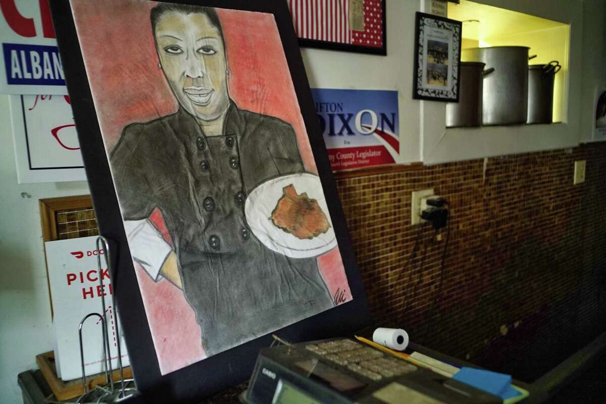 A view of a portrait of Kizzy Williams, owner of Allie B's Cozy Kitchen, at her restaurant on Tuesday, June 11, 2019, in Albany, N.Y. The painting was done by local artist Ali. (Paul Buckowski/Times Union)