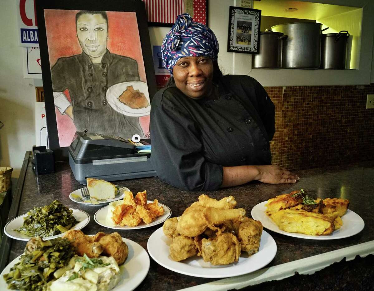 Kizzy Williams, owner of Allie B's Cozy Kitchen, poses with some of her food on Tuesday, June 11, 2019, in Albany. She will be on the new Food Network show "Chef Boot Camp" in April 2021. (Paul Buckowski/Times Union)
