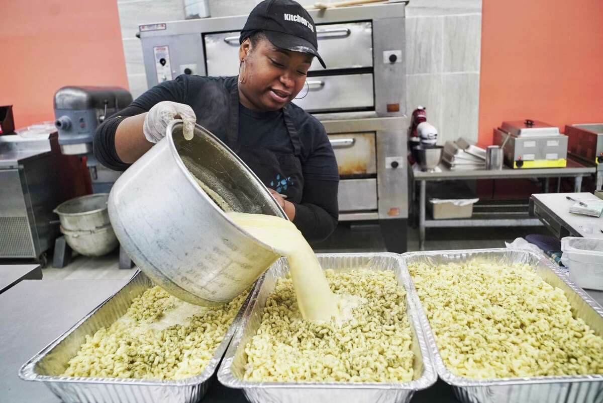 Emrys Young, owner of Kitchen 216, prepares pans of macaroni and cheese on Tuesday, June 11, 2019, in Albany, N.Y. (Paul Buckowski/Times Union)