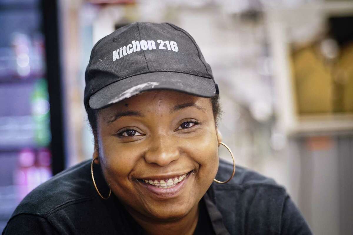 Emrys Young, owner of Kitchen 216, poses in the restaurant in 2019.