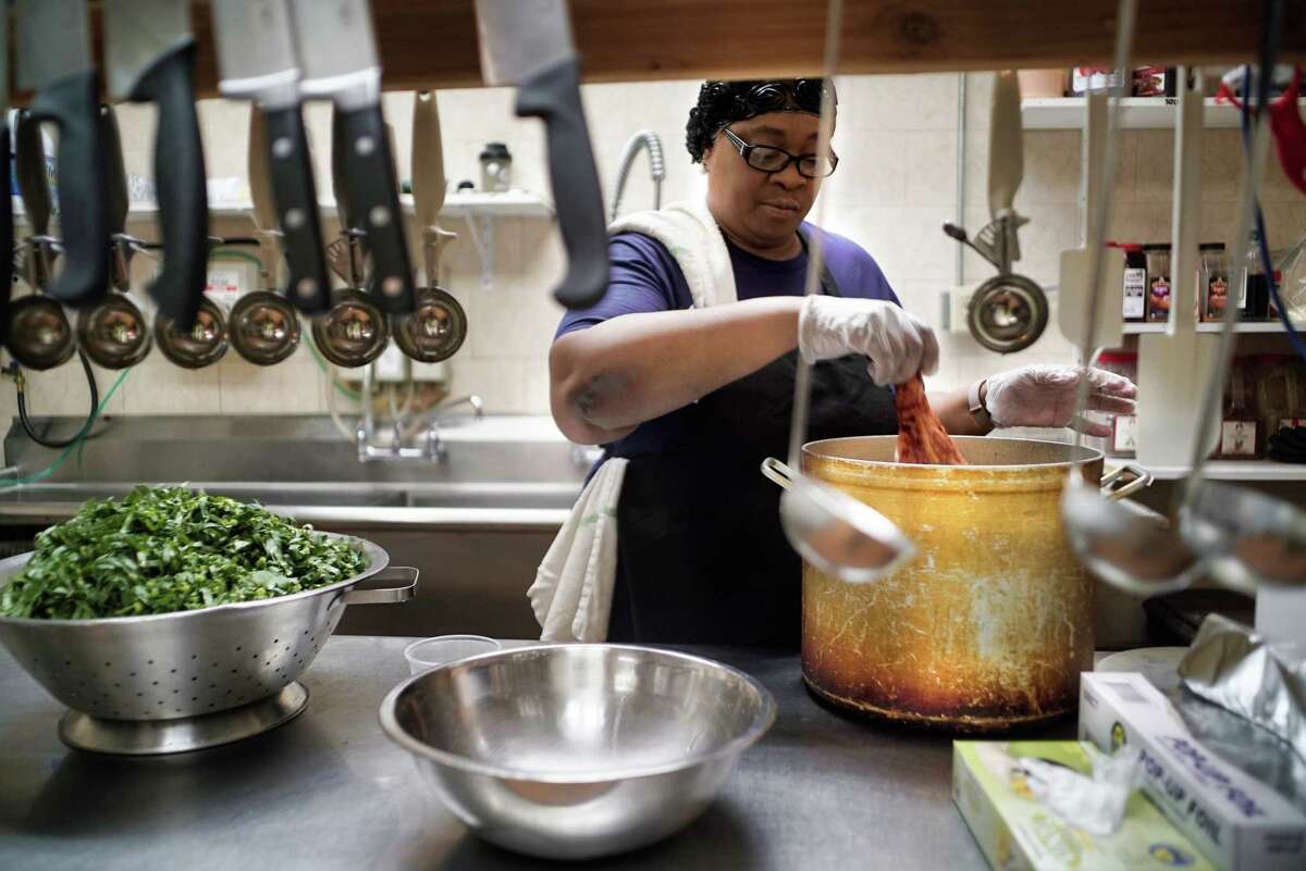 Amanda Thompson, owner of Ya-Ya's House, makes collard greens in the kitchen on Wednesday, June 19, 2019, in Schenectady, N.Y. (Paul Buckowski/Times Union)