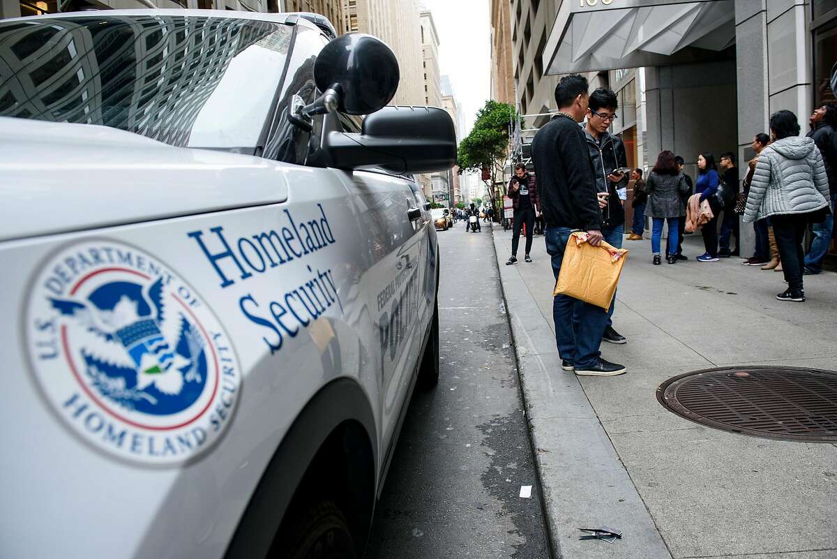 A Department of Homeland Security police vehicle is seen as people wait with their paperwork outside of San Francisco Immigration Court in San Francisco, Calif., on Thursday, January 31, 2019.
