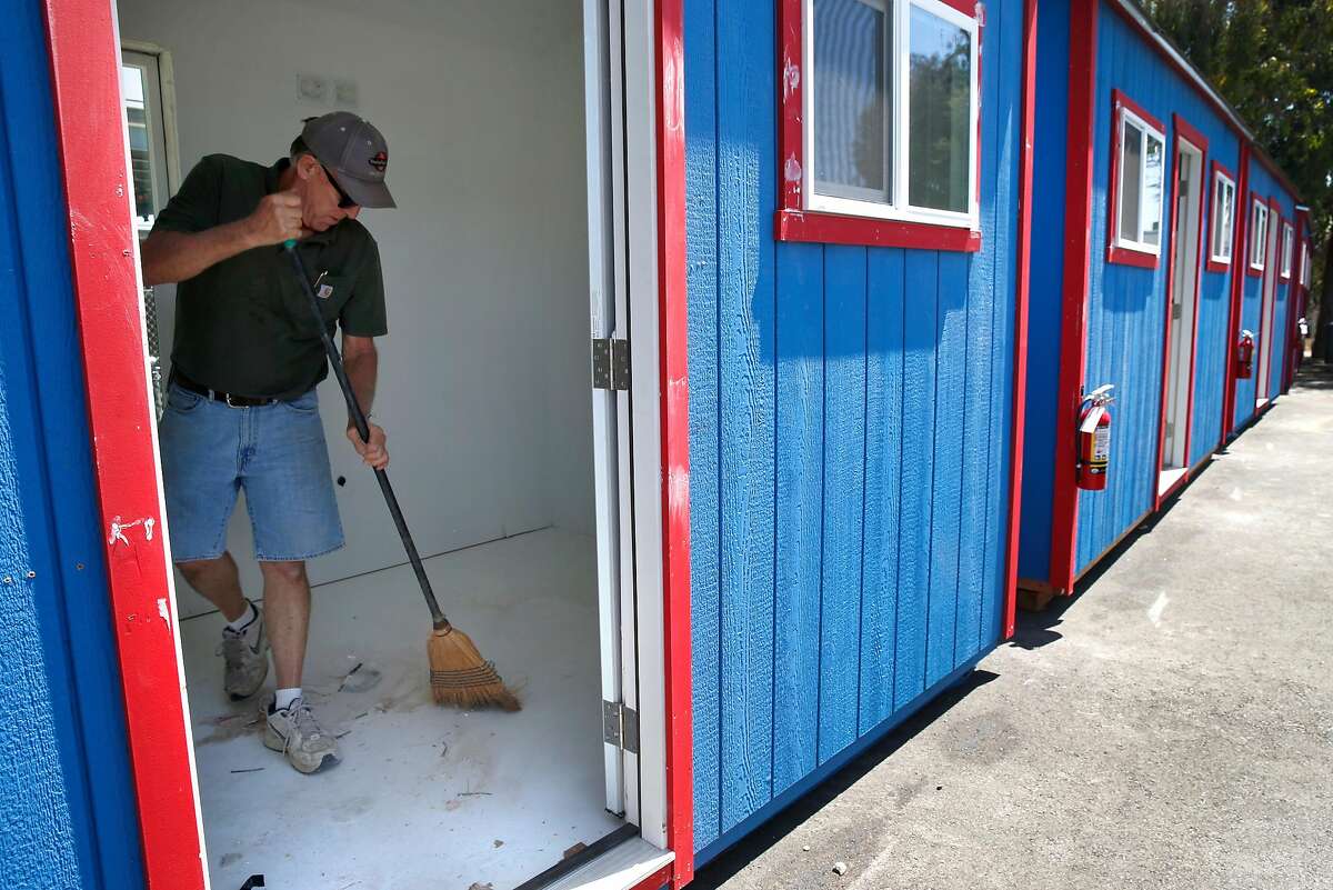 Bill Kelley, of California Sheds, prepares a home in a new community of portable sheds for homeless residents below the MacMarthur Maze in Oakland, Calif. on Wednesday, July 3, 2019. The first of the 80 or so residents are scheduled to move into the tiny homes near Wood and 34th streets on Sunday.