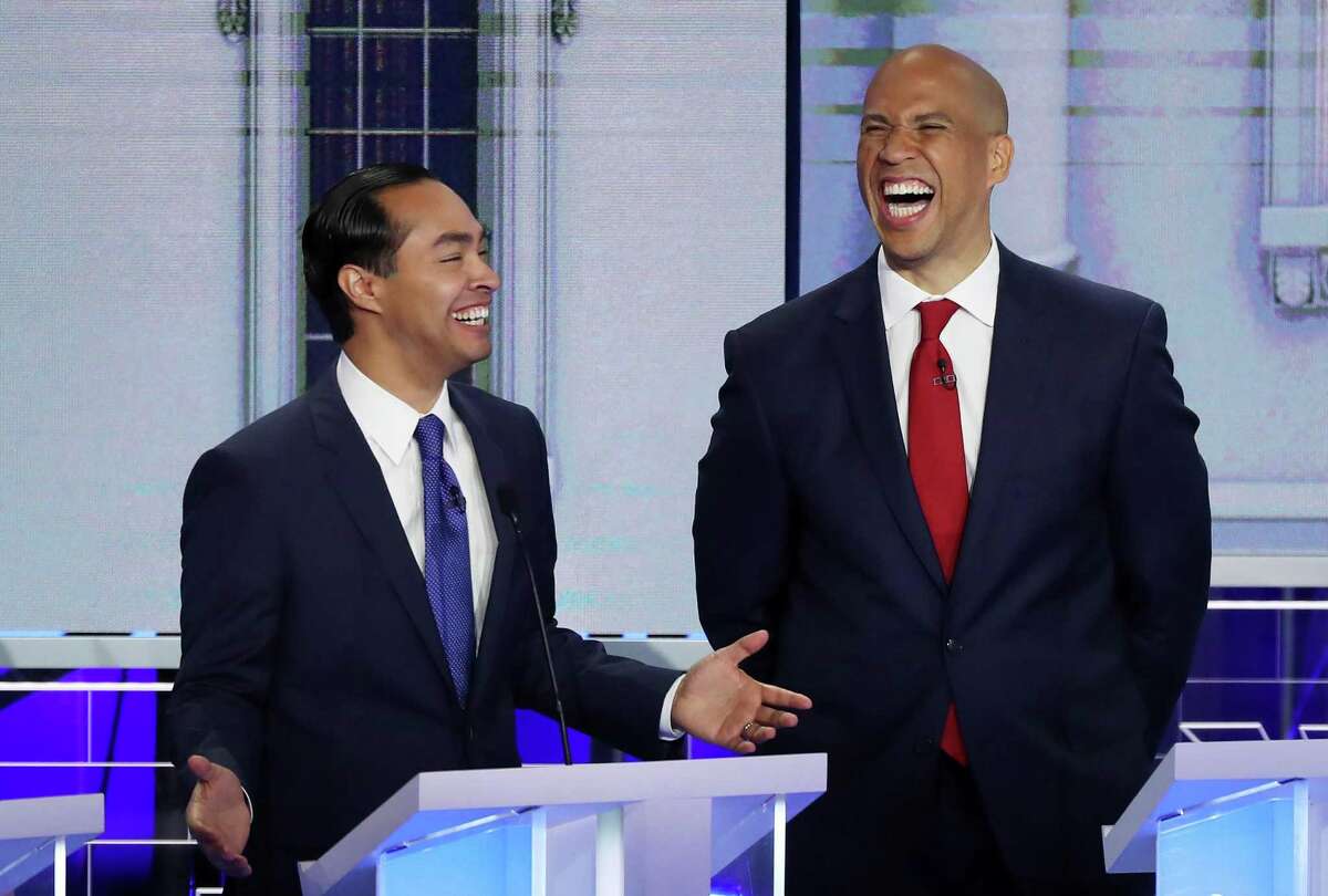 MIAMI, FLORIDA - JUNE 26: Former housing secretary Julian Castro and Sen. Cory Booker (D-NJ) react during the first night of the Democratic presidential debate on June 26, 2019 in Miami, Florida. A field of 20 Democratic presidential candidates was split into two groups of 10 for the first debate of the 2020 election, taking place over two nights at Knight Concert Hall of the Adrienne Arsht Center for the Performing Arts of Miami-Dade County, hosted by NBC News, MSNBC, and Telemundo. (Photo by Joe Raedle/Getty Images)