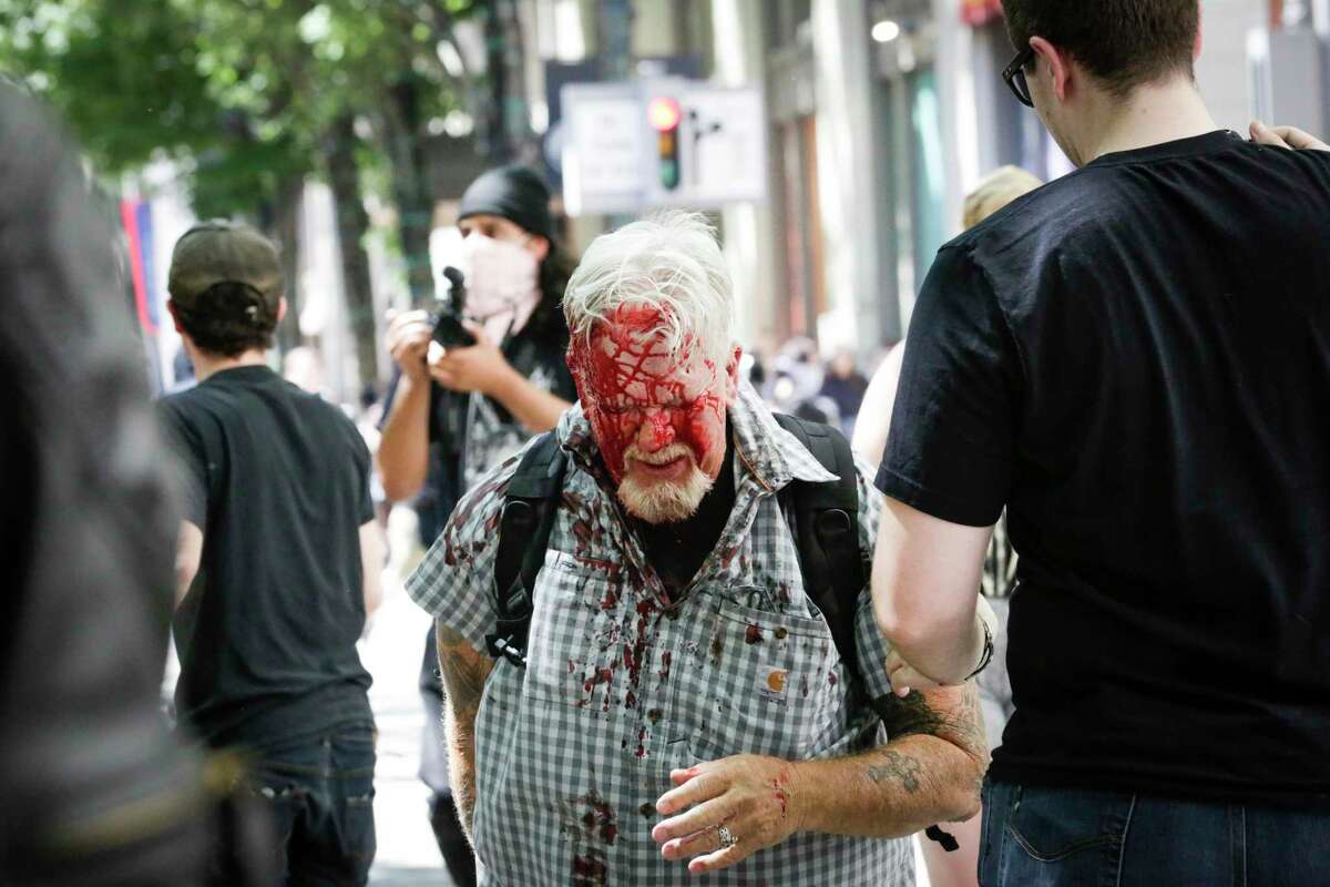 PORTLAND, OR - JUNE 29: (EDITORS NOTE: Image contains graphic content.) The Rose City Antifa brutally attacks an unidentified right aligning man at Pioneer Courthouse Square on June 29, 2019 in Portland, Oregon. Several groups from the left and right clashed after competing demonstrations at Pioneer Square, Chapman Square, and Waterfront Park spilled into the streets. According to police, medics treated eight people and three people were arrested during the demonstrations. (Photo by Moriah Ratner/Getty Images)
