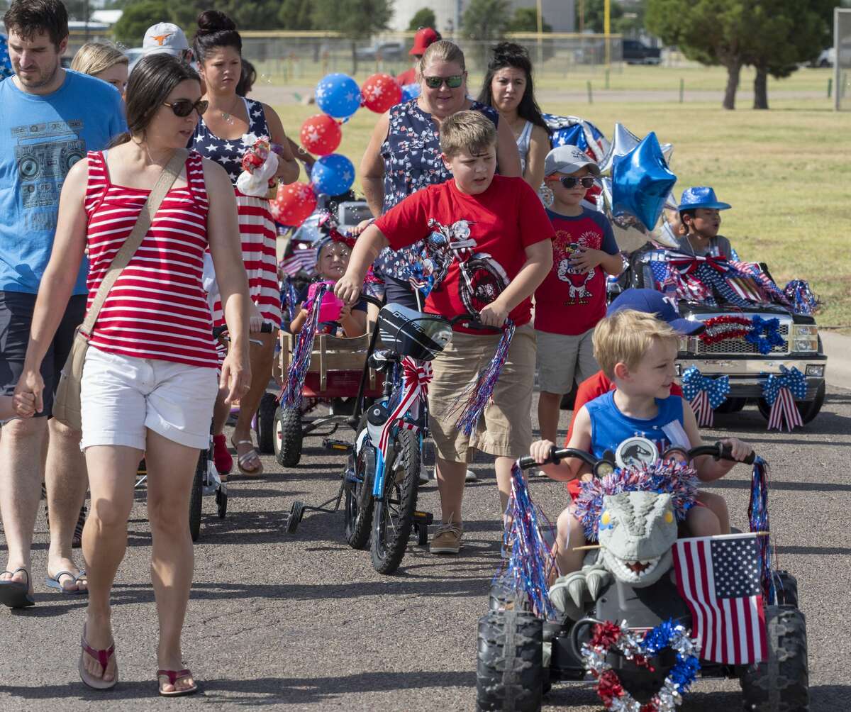 Midland children and parents make their way through Hogan Park 07/04/19 morning for the 57th annual Children's Parade presented by the Col. Theunis Chapter of the Daughters of the American Revolution. Tim Fischer/Reporter-Telegram