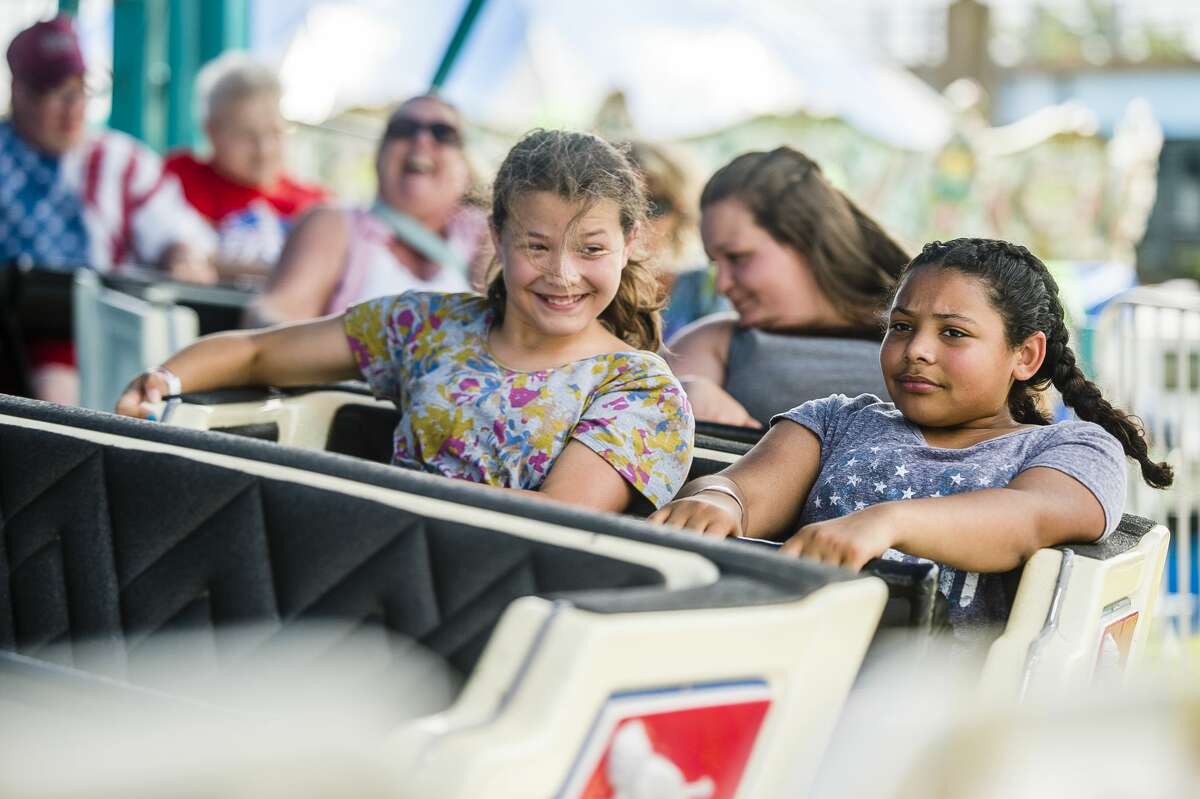 Guests enjoy carnival rides, games and refreshments on Thursday, July 4, 2019 at the Skerbeck Family Carnival in Bay City. (Katy Kildee/kkildee@mdn.net)