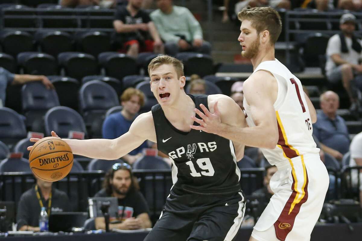 San Antonio Spurs Luka Samanic (19) goes to the basket as Cleveland Cavaliers Dean Wade, right, defends in the first half of a NBA Summer League game Monday, July 1, 2019, in Salt Lake City. (AP Photo/Rick Bowmer)