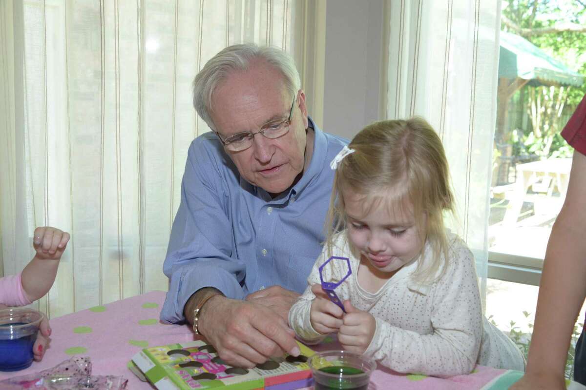 Bill King coloring Easter eggs with his granddaughter