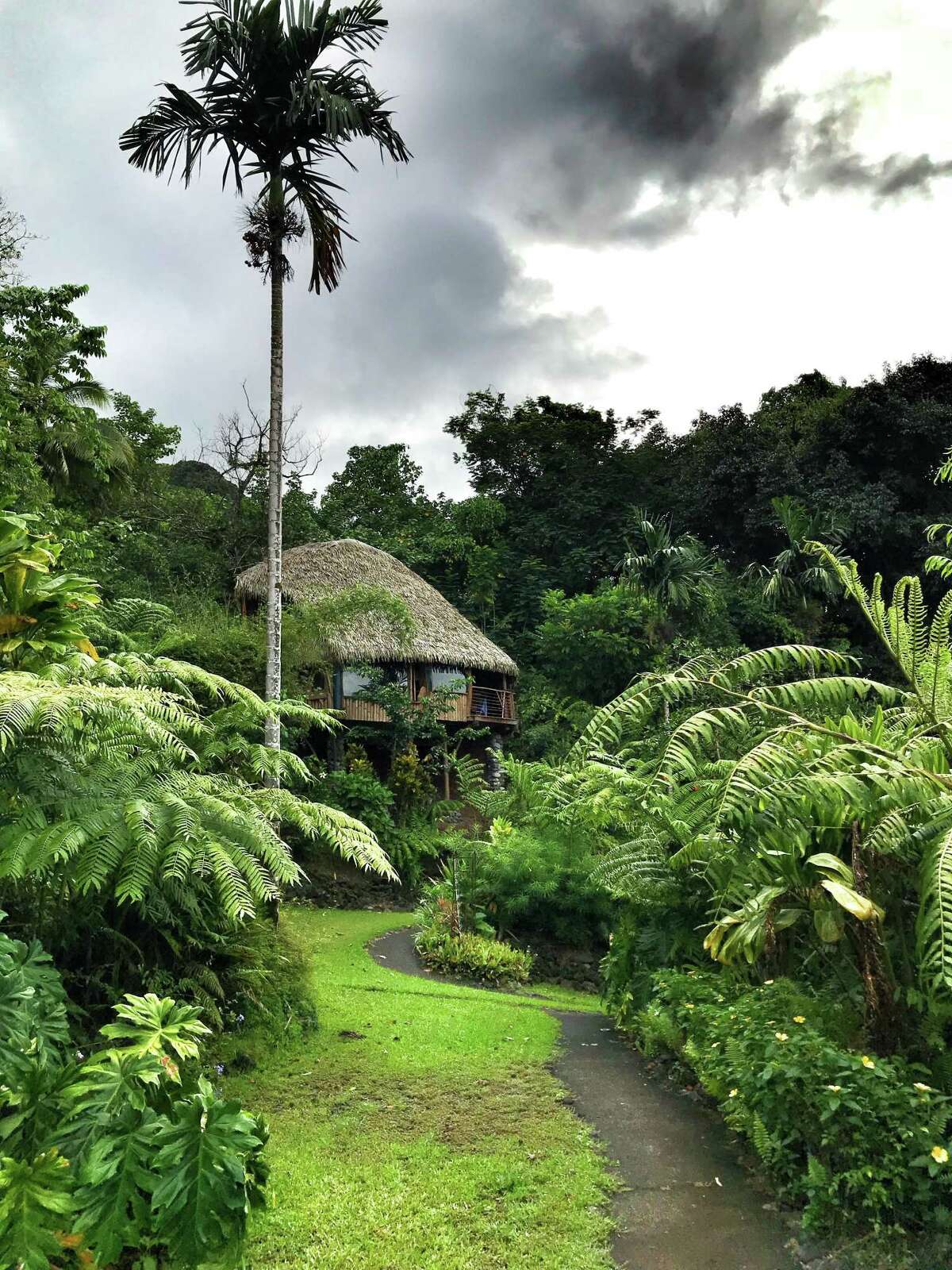 Guests stay in thatched roof huts at Vanira Lodge, Tahiti Iti.