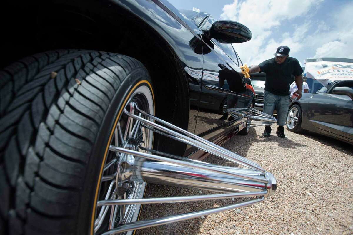 L.A. Barrow, of Houma, La., polishes his Black Cherry 2003 Chevrolet Monte Carlo SS at the Houston SLAB Holiday at 8th Wonder Brewery on Sunday, June 23, 2019, in Houston.