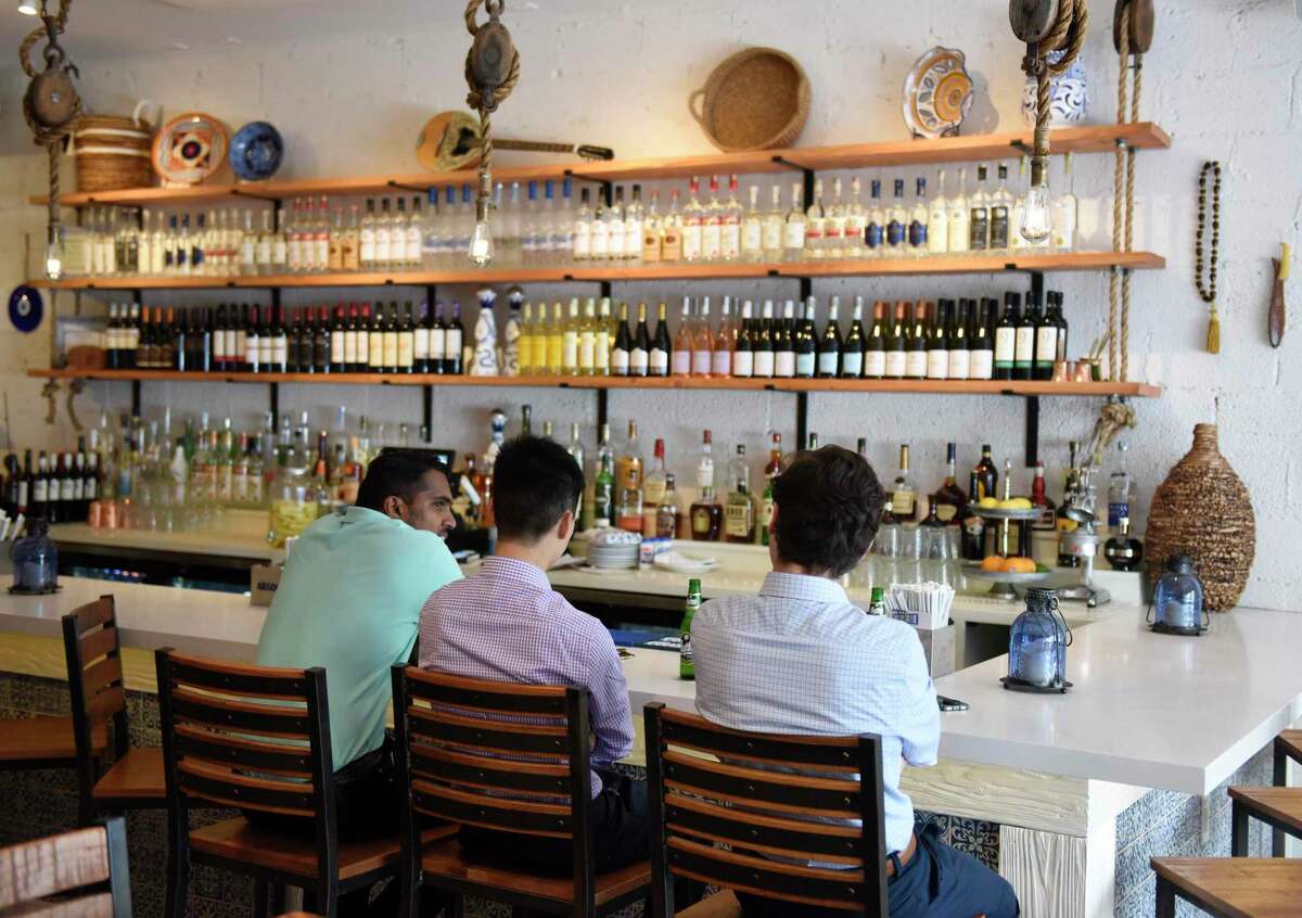 Patrons have a drink at the bar at Kouzina, a Greek taverna and bar at 223 Main St., in downtown Stamford, Conn. on Wednesday, July 3, 2019.