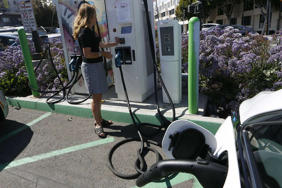 Esther M. de Frutos, an Uber driver of one year, charges her Chevy Bolt EV electric car at a Walgreens on Monday, June 18, 2018 in San Francisco, Calif.