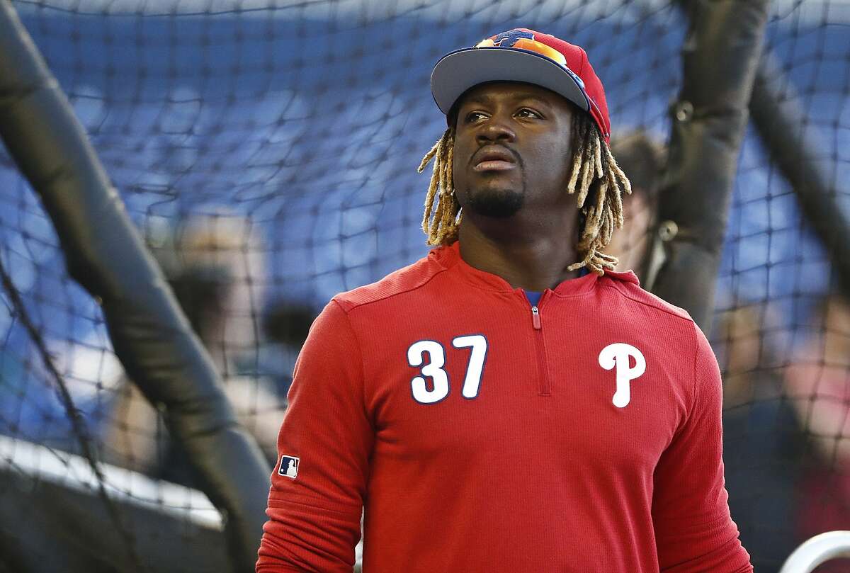 FILE - In this April 12, 2019, file photo, Philadelphia Phillies center fielder Odubel Herrera gets ready for the team's baseball game against the Miami Marlins in Miami. Herrera has accepted a suspension for the rest of the season under Major League Baseball’s domestic violence policy. The commissioner’s office announced the decision Friday, July 5, two days after domestic assault charges against him in Atlantic City, N.J., were dismissed. He had been charged with simple assault and knowingly causing bodily injury stemming from an incident on May 27 at the Golden Nugget Casino. The woman, his girlfriend, declined to press charges. (AP Photo/Brynn Anderson, File)