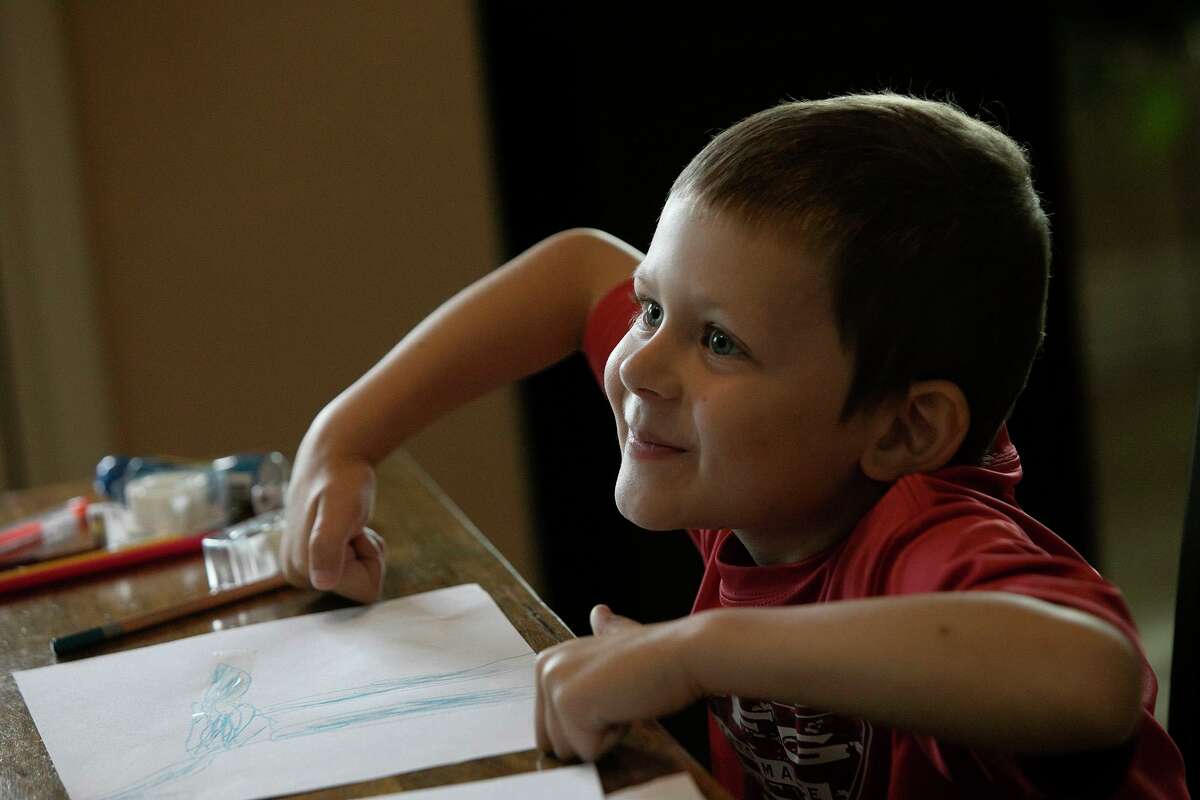 Rowland, who has been fighting acute lymphoblastic leukemia, plays a drawing game at home in New Braunfels.
