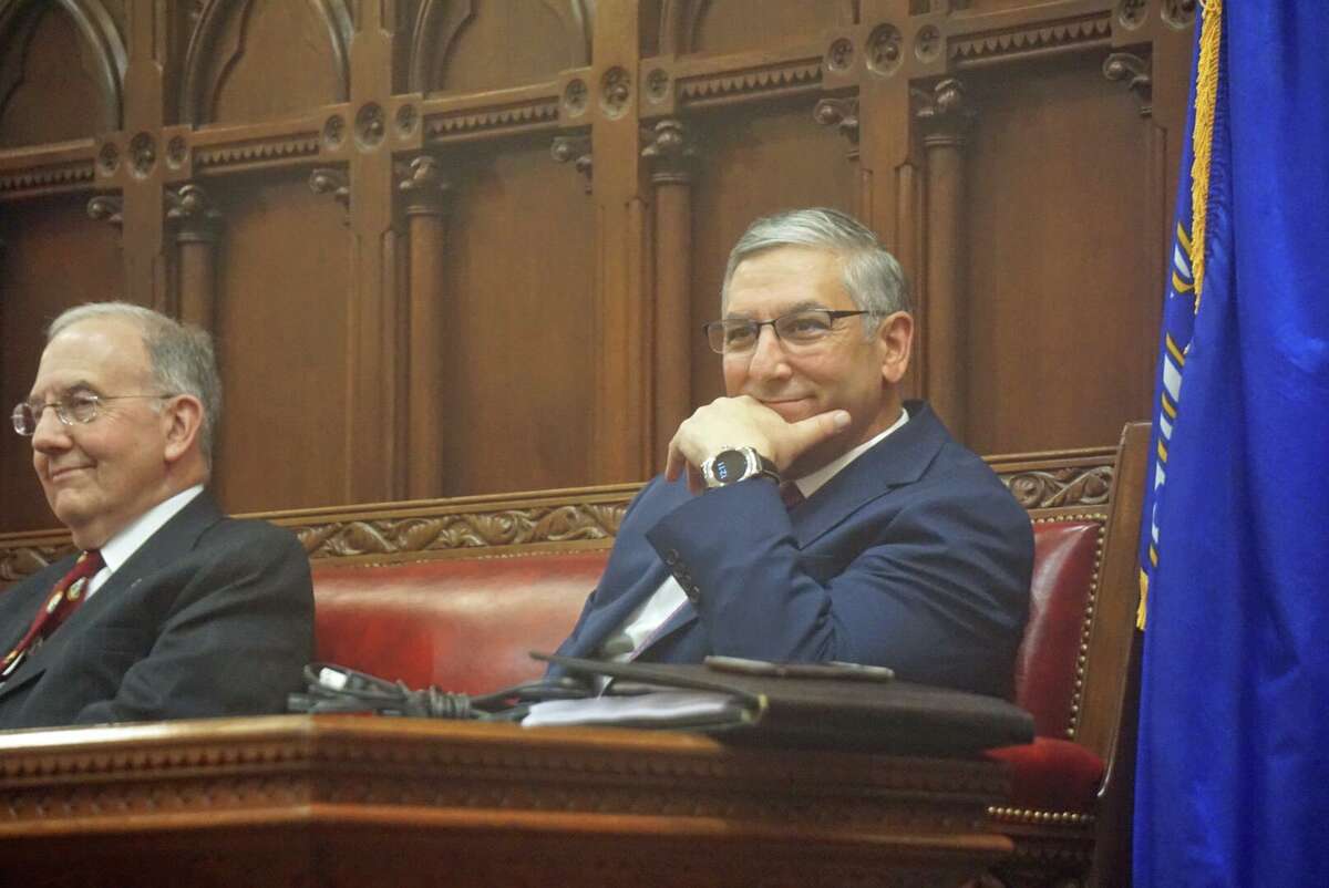 Senate Republican Leader Len Fasano, R-North Haven, right, sat with Senate President Pro Tempore Martin Looney, D-New Haven, leaving a space between them at the close of the 2018 legislative session in the early hours of Thursday May 10, 2018 at the Capitol in Hartford, Conn.