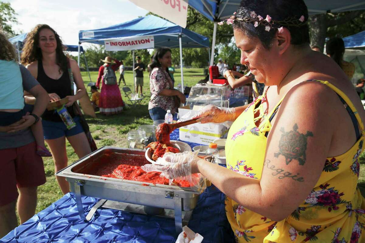 Sandra Contreras serves up fried kofta during the second annual Festival of Chariots (Ratha Yatra) at Woodlawn Lake on July 6, 2019.