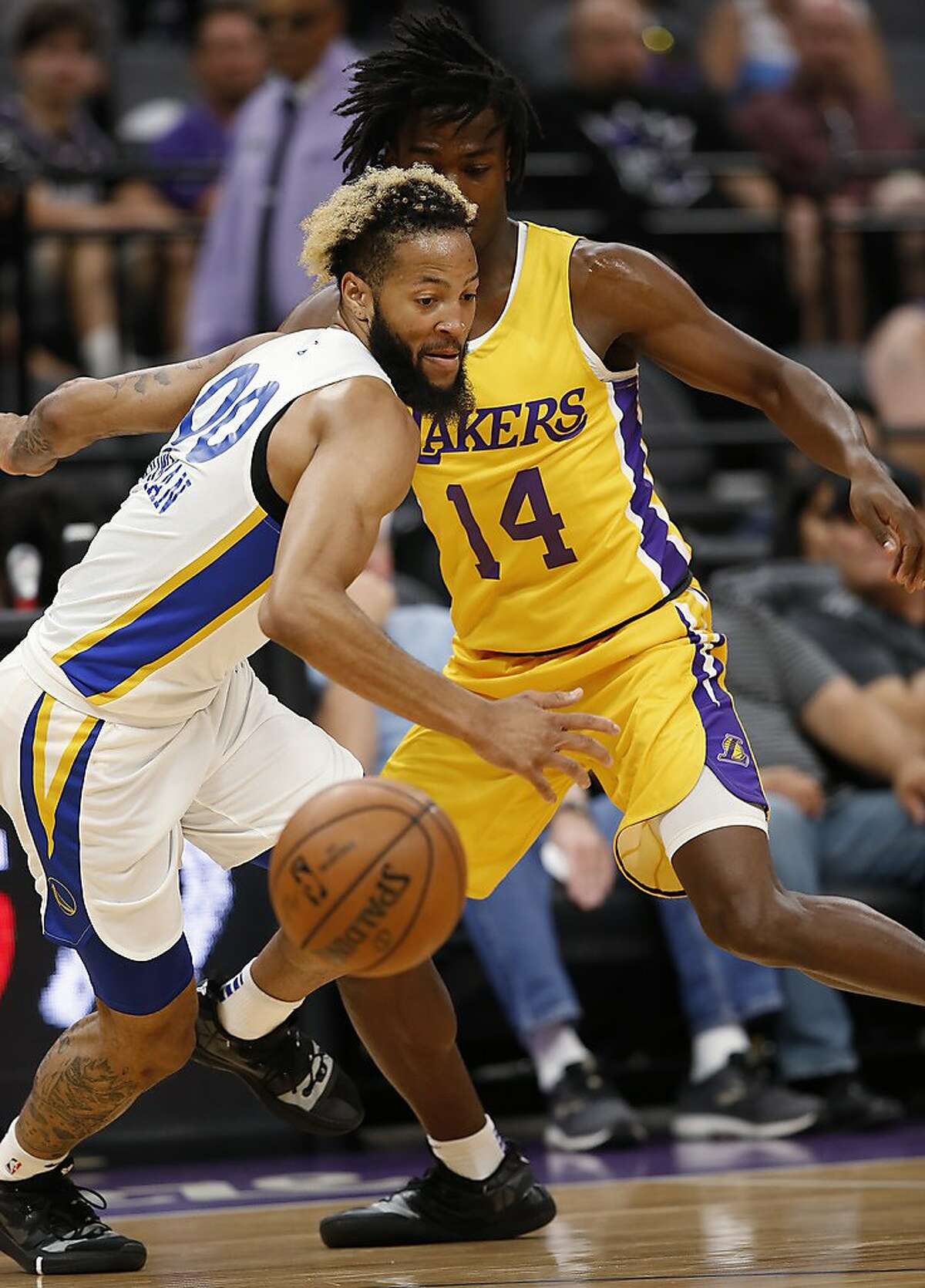Golden State Warriors guard Ky Bowman, left, and Los Angeles Lakers guard Marcus Allen right, chase the ball during the first half of an NBA basketball summer league game in Sacramento, Calif., Tuesday, July 2, 2019. (AP Photo/Rich Pedroncelli)
