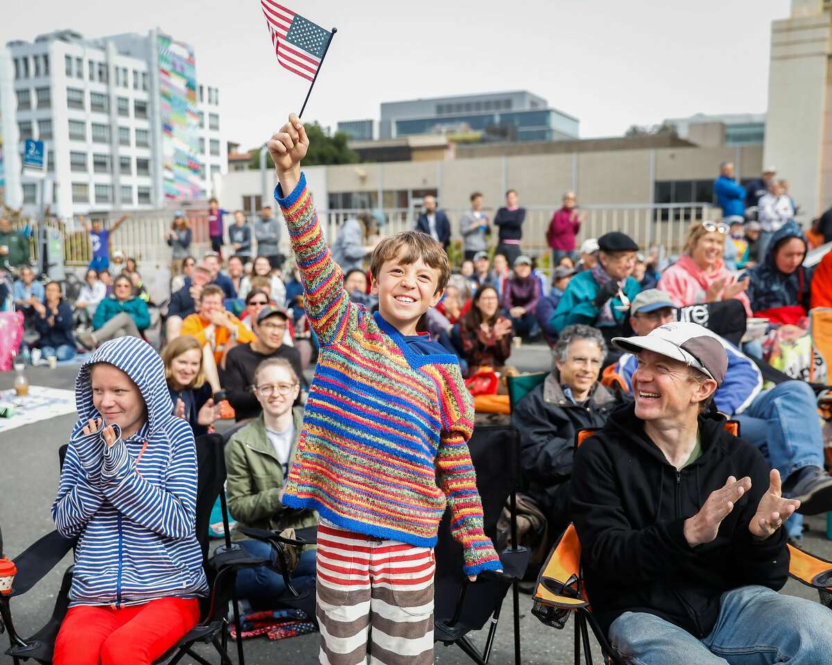 Fan Tom Martin, 10, waves a flag in the air after the USA team scored their second goal in the FIFA Women's World Cup Finals between USA and Netherlands in Berkeley, California, on Sunday, July 7, 2019. USA defeated the Netherlands 2-0.