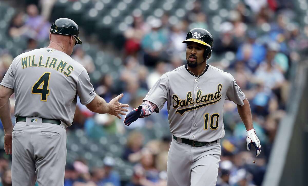 Seattle Mariners' Omar Narvaez (22) is greeted by manager Scott